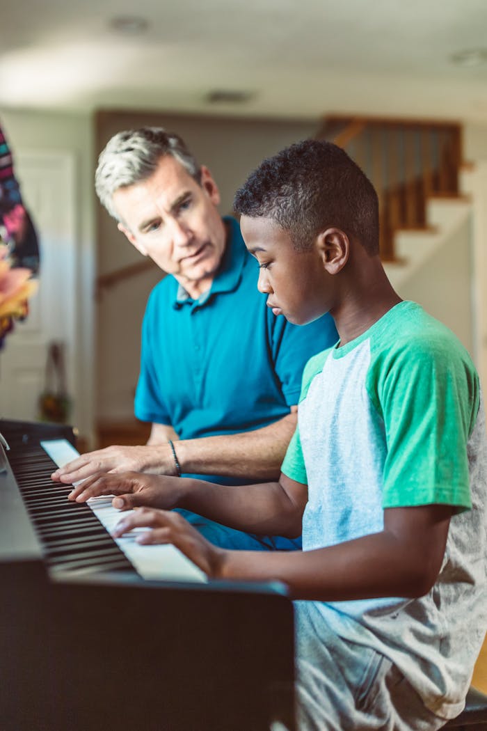 A teacher guiding a child on the piano, symbolizing learning and connection.